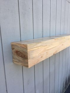 a wooden shelf on the side of a building