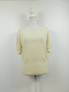 "Vintage 80s Ivory Cream Holey Textured Crochet Knitted Stretch Ribbed Minimal Crewneck Short Sleeve Sweater Top Medium This item is used but in good condition. Has no rips, tears, staining, and hardly any wear and tear. No sz tag. Appropriate for any casual or evening occasion Measurements: Bust: 40 \" Waist: 40\" Top to Bottom: 24\" Domestic Customers: 1st Class (2-5 days) International Customers: Calculated rate (varies by listing due to weight). Any flaws will be noted in item description Fi Retro Textured Knit Sweater For Spring, Retro Cream Sweater For Spring, Vintage Beige Tops For Winter, Vintage Cream Top For Fall, Retro Cream Top For Fall, Cream Pointelle Knit Top For Winter, Fitted Off White Knit Sweater, Off White Knitted Tops, Vintage Textured Knit Tops For Winter