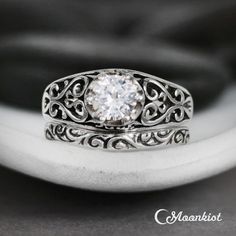 a close up of a ring with a diamond in it