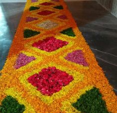 an elaborately decorated long table with flowers on the top and bottom, is shown