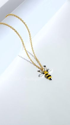 New 14k Gold Plated Bumble Bee Charm Necklace, Chain Necklace, Gift for Her This stylish 14k gold-plated chain necklace features a playful beaded bee charm, perfect for adding a fun touch to any outfit. Handmade in the United Kingdom and adjustable (42cm + 5cm extender), its an ideal gift for birthdays, anniversaries, Valentine's Day, Mother's Day, or just because.  S I Z I N G Please note many of my bracelets and necklaces come with adjustable parts, but there are certain bracelets made with stretch cord which allows some flexibility on the sizing. The bracelets made with stretch cord usually can stretch up to 2-3 sizes, please refer to the exact sizes in the individual item descriptions on my listings. Whether purchased for yourself or as a special gift for someone else, please measure t Bee Necklace, Bee Charms, Jewelry For Her, Bumble Bee, Bracelet Making, Ideal Gift, Jewelry Sets, Charm Necklace, Special Gifts