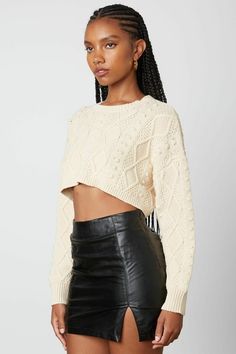 Final Sale-Get it before it's gone! Go out and enjoy the cooler weather in the Toby Natural Cable Knit Cropped Sweater! Soft cable knit, in a natural hue, shapes this cropped sweater that has a crew neckline and long sleeves with drop shoulders. Contrasting ribbed knit decorates the neckline, cuffs, and hem. The slightly wide-cut bodice ends at a cropped hem. DETAILS & CARE: Polyester. Machine wash cold. Imported. Knit Cropped Sweater, Sweater Boho, Boho Pink, Cropped Knit Sweater, Pink Boho, Crop Sweater, Cropped Sweater, Cable Knit, Leather Skirt