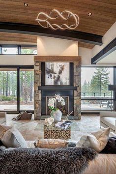 a living room with couches, chairs and a fire place in the middle of it