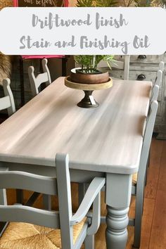 a dining room table with chairs and a cake plate on it, in front of a wood finish stain and finishing oil