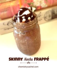 a chocolate smoothie in a mason jar with whipped cream and chocolate drizzle on top