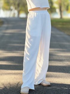 "With a subtle texture unique to double gauze fabric, these pants exude a casual yet sophisticated look that can be dressed up or down. Side pockets add a functional touch, keeping essentials close at hand. Whether you're running errands, enjoying a day out, or unwinding after a long day, these muslin pants are your go-to choice for a blend of luxury and practicality. Pair them with a simple tee or a flowy blouse to complete your chic, laid-back ensemble. Size S Waist 26-28 Hip   38\" Long  38\" Size M Waist 30-32\" Hip   42\" Long  38\" Size L Waist 34-36\" Hip   46\" Long  38\"" Elegant Beach Pants With Elastic Waistband, Elegant Beach Bottoms With Pockets, Casual Summer Pants With Crinkle Texture, Spring Cotton Bottoms With Crinkle Texture, Elegant Cotton Beach Bottoms, Casual Bottoms With Crinkle Texture For Spring, Elegant Cotton Beach Pants, Chic Spring Bottoms With Crinkle Texture, Summer Loungewear Pants With Crinkle Texture