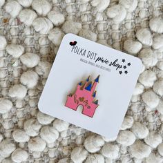 a pink castle pin sitting on top of a pile of white balls