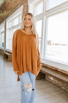 We're bringing it back to the basics with our Quinn Dolman V-Neck Tunic! Our tunic features a v-neckline, dolman style long sleeves, a semi-loose fit, and a high-low hem. With its super soft buttery fabric our top is a must have in every closet this season! Wear it with your favorite jeans or leggings for a comfy yet stylish look! Fall V-neck Top, V-neck Long Sleeve Top For Fall, Fall V-neck Loungewear Tops, Casual V-neck Long Sleeve Top For Fall, Oversized V-neck Long Sleeve Top For Fall, Fall Beach Tunic With V-neck, V-neck Long Sleeve Top For Winter Loungewear, Brown V-neck Tops For Fall, Elegant Fall V-neck Tunic