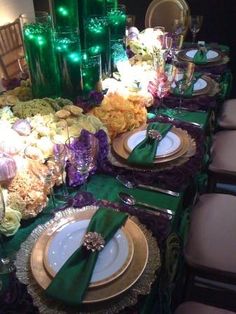 the table is set with green and gold plates