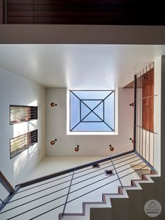 an empty room with stairs leading up to the skylight