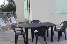 an outdoor table and chairs on a patio