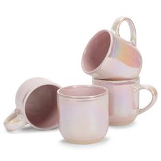 three pink coffee mugs sitting next to each other