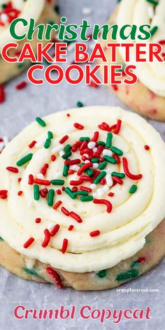 christmas cake batter cookies with sprinkles and white frosting on parchment paper