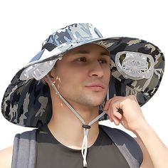 a man wearing a sun hat while standing in front of a white background