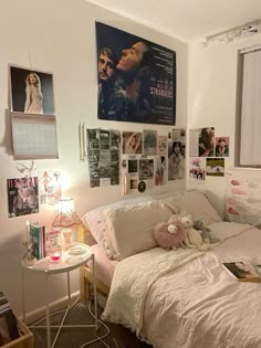 a bedroom with posters and pictures on the wall