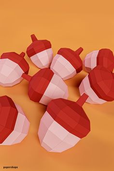 several red and white pieces of paper on an orange surface with one piece cut out to look like hearts