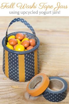 an upcycled yogurt jar with washi tape and oranges in it