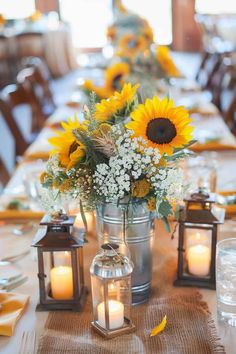 sunflowers and baby's breath flowers are in a vase on the table