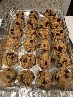 an aluminum pan filled with cookies and raisins