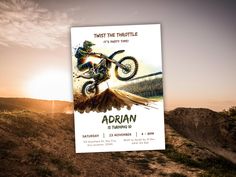 an advertisement for the upcoming motocross event is displayed in front of a sunset