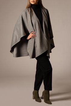 Design: Glamorous and very chic cape.     Material Composition: 70% Royal Suri Alpaca, 30% Wool.     Origin: Made in Peru.     Ethical Credentials: Fairtrade certified.     Additional Feature: Naturally dyed.     Quality: Made from high-quality alpaca wool, known for its softness, warmth, and sustainable properties.     Ideal for: Fashion-conscious individuals looking for eco-friendly alternatives. Winter Poncho With Cape Sleeves, Chic Winter Shawl Cape, Elegant Cape Poncho For Work, Chic Cape Shawl For Fall, Elegant Oversized Poncho Cape, Elegant Oversized Cape Poncho, Chic Fall Cape Shawl, Elegant Fall Poncho Cape, Chic Fall Capelet