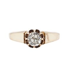 an old - fashioned diamond ring with two tone gold and brown diamonds in the center