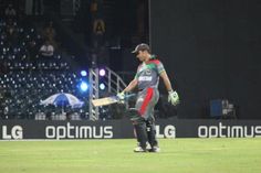 a man holding a baseball bat on top of a field