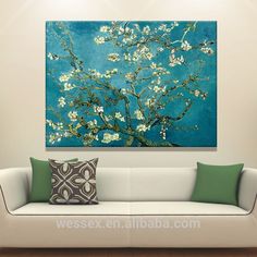 the painting is hanging on the wall in the living room, it looks like an almond blossoming tree