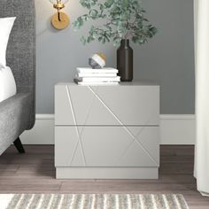 a bedroom with grey walls and white furniture