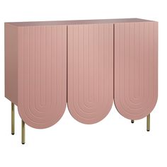 a pink cabinet with gold legs and three circular shapes on the front, against a white background