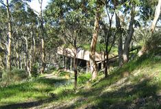 an old wooden structure in the middle of some trees