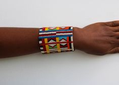 African beaded bracelets, Maasai Cuff Bracelets, Maasai Wrist bracelets, Beaded bangles, Beaded Cuff bracelets, Christmas gift, Moms gift The bracelet is made by the Maasai women in Kenya.  It is beautiful and can compliment any outfit. Available in medium and large size Medium size: fits a standard wrist size of 7.5 inches Large Size: fits a wrist size of 8.5 inches Shipping fee is for the first item only. Other items ship for FREE! Shipping via DHL Express that takes 3-5 days to be delivered. To view more items from our shop, kindly click here: nkoroicrafts.etsy.com Thank you for visiting! Multicolor Hand Wrapped Bangle For Gift, Multicolor Hand Wrapped Bangle As Gift, Multicolor Cuff Bracelet For Festivals And Gifts, Multicolor Cuff Bracelet As Gift For Festivals, Traditional Beaded Bangle As Gift, Traditional Multicolor Cuff Bracelet As Gift, Traditional Beaded Wristband Gift, Traditional Multicolor Stretch Bracelet As Gift, Traditional Multicolor Rectangular Beaded Bracelets