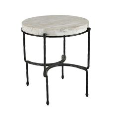 a white marble top table with black iron legs and an oval design on the base