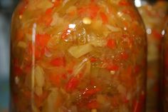 a jar filled with lots of food sitting on top of a table