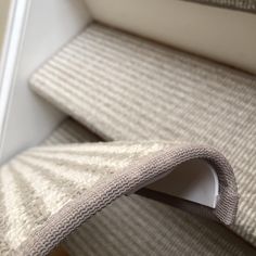 a close up view of a carpeted stair tread