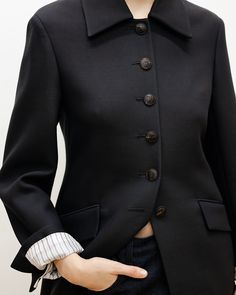 The Rebecca jacket features a sculptural high neck, wide collar, and monogram horn buttons - blending strong tailoring with a refined feminine feel.  #VeronicaDePiante Luxury Structured Outerwear With Lapel Collar, Wool Outerwear With Structured Boning And Lapel Collar, Black Outerwear With Structured Boning And Lapel Collar, Luxury Double-breasted Wool Coat With Concealed Placket, Wool Single-breasted Outerwear With Fold-down Collar, Knitwear Tops, Shoe Collection, Outerwear Jackets, High Neck