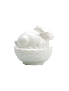 a white ceramic bowl with a rabbit in it's shell on a white background