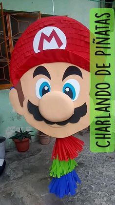 a large paper cut out of mario on the ground