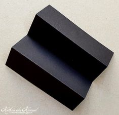 two black boxes sitting on top of a white table