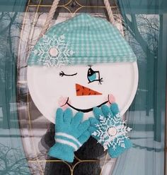 a snowman is wearing gloves and a hat