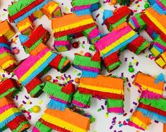 there are many colorful pieces of cake that have been made to look like pinatas