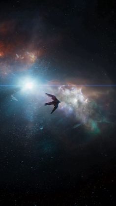 an image of a space shuttle flying in the sky with stars and clouds around it