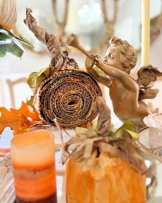 a table topped with candles and vases filled with autumn decorations