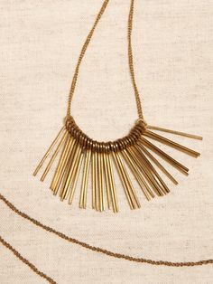 WANDERLUST COLLECTION: Designed to capture our love of adventure—it speaks to the places traveled and those yet to visit.  The pieces are hand-crafted by skilled artisans with authentic materials.  A sweep of brass feathers swing from a brass chain Bohemian Gold Brass Choker, Gold Brass Bohemian Choker, Bohemian Brass Collectible Necklace, Luxury Tarnish-resistant Brass Necklaces, Gold Feather Necklace, Feather Necklaces, Brass Chain, Tassel Necklace, Womens Jewelry Necklace