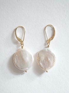 A pair of Pearl drop earrings on 14k yellow gold. each Pearl is approximately 3/4” in diameter 14k Gold Filled Round Earrings, Classic Round Earrings With French Hook, 14k Gold Dangle Pearl Drop Jewelry, 14k Gold Linear Pearl Drop Earrings, Classic Round French Hook Earrings, White 14k Gold Timeless Earrings, Timeless White 14k Gold Earrings, Classic French Hook Earrings, Fine Jewelry 14k Gold Drop Pearl Earrings