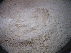 a pan filled with white flour sitting on top of a stove