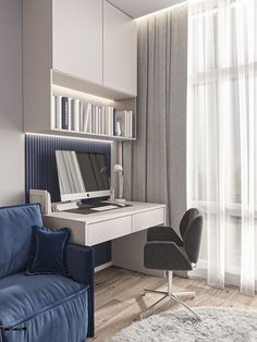 a blue couch sitting in front of a computer desk