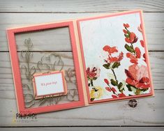 a close up of a card with flowers on it and a small box in the middle