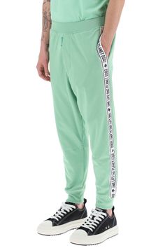 Dsquared2 track pants crafted in cotton and recycled polyester blend jersey. They feature elasticated waistband, side seam pockets, hem with elasticated cuffs and they're characterized by contrasting side bands with logo. Decorated with logo label on the fly. Relaxed fit. The model is 187 cm tall and wears size L. Size Info STANDARD Color Detail Green Made In Italy Material 55% PL 45% CO Season One spring Season Two summer Product clothing Brand Dsquared2 Size And Fit Trench Dress, Latest Fashion Design, Track Pant, Logo Label, The Fly, Knitwear Cardigan, Pant Shirt, Jeans Dress, Emporio Armani