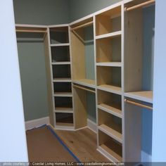 an empty walk in closet with shelves and drawers